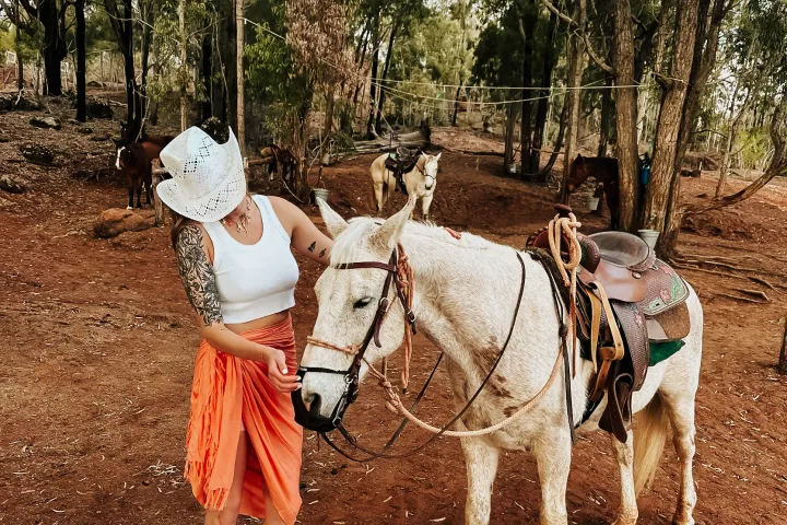 a group of people standing next to a horse