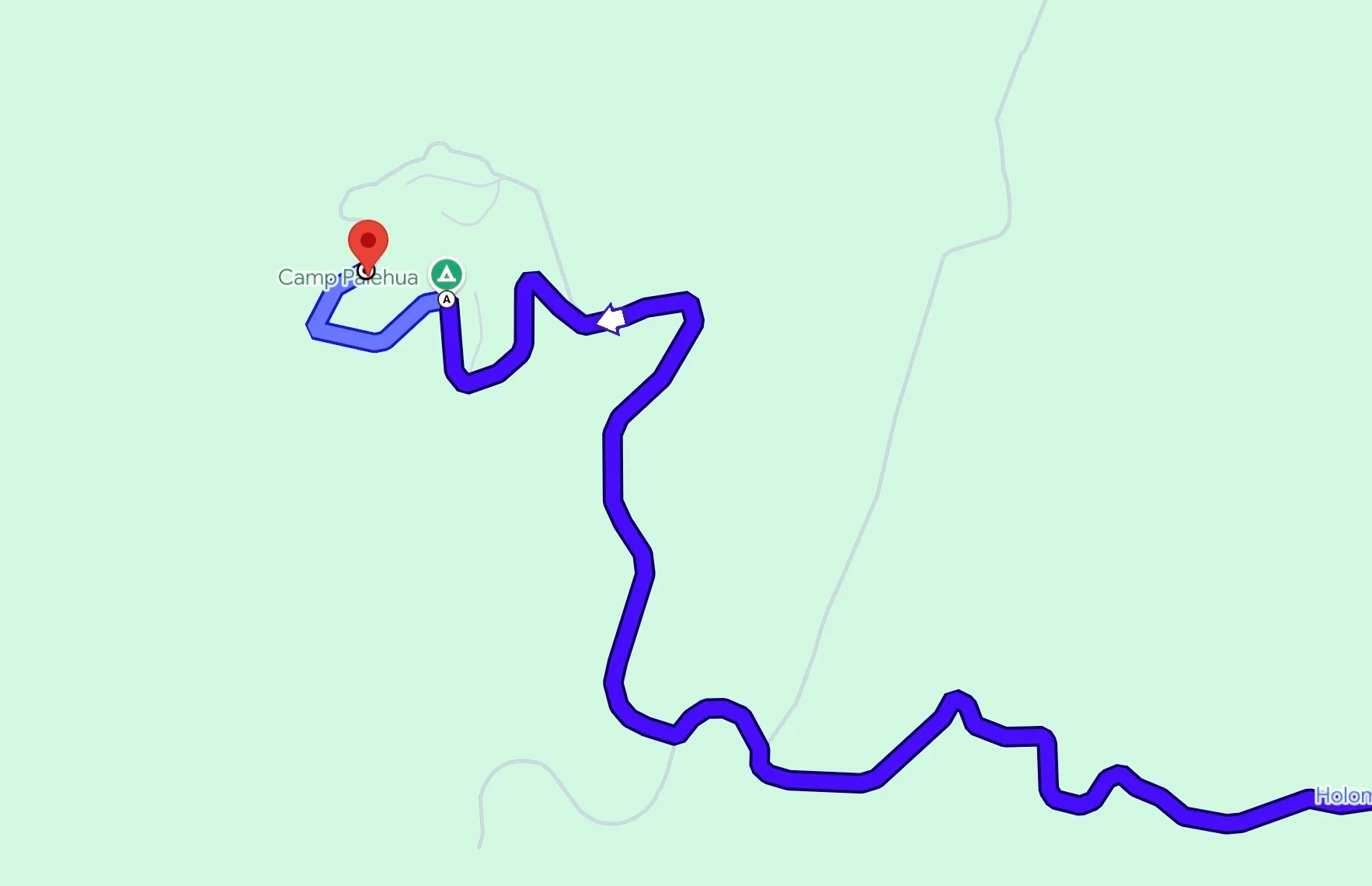 Map showing a winding blue route to Camp Pīnehua with a red location pin.